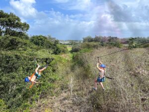 Check out this honest North Shore Oahu zipline tour review by top Hawaii blog Hawaii Travel with Kids. Image of Marcie Cheung of Hawaii Travel with Kids and her son at CLIMB Works Keana Farms in North Shore Oahu.