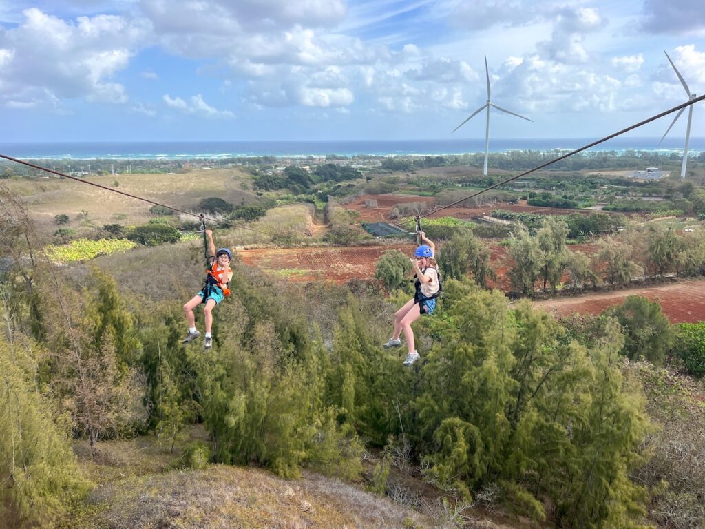 Image of Marcie Cheung of Hawaii Travel with Kids and her son at CLIMB Works Keana Farms, a North Shore Oahu zipline tour.