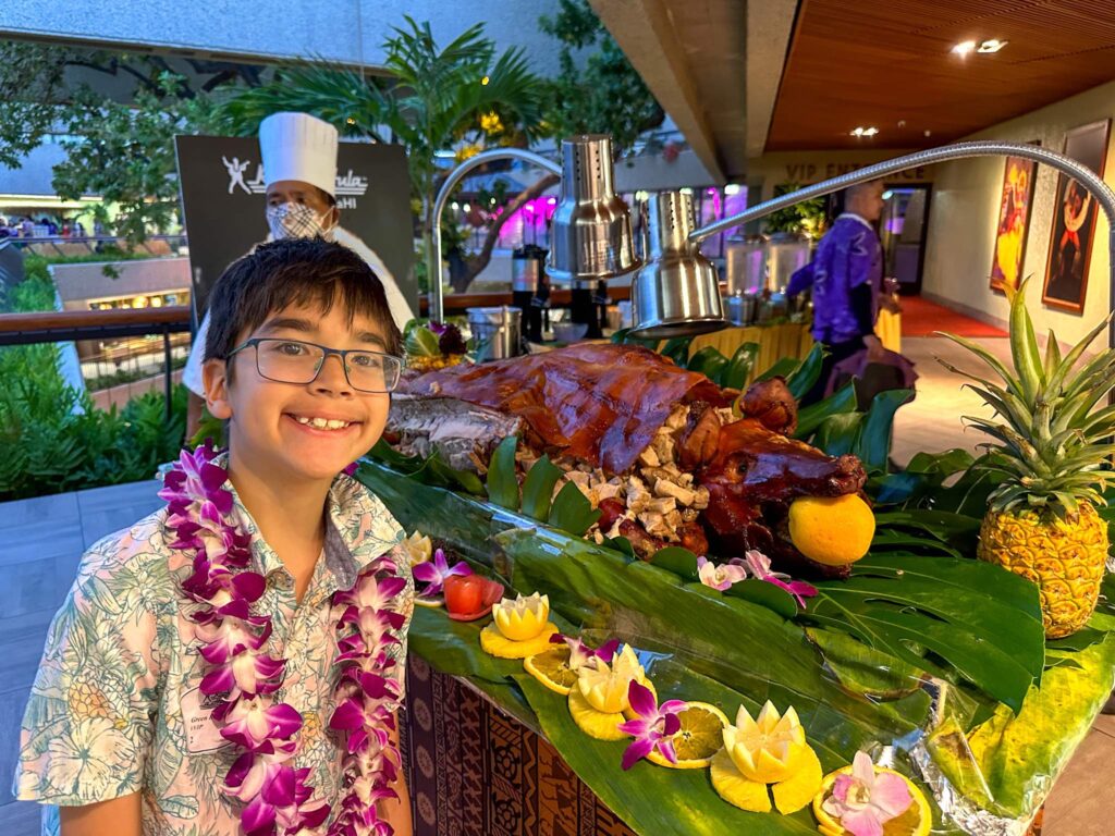 Image of a boy in front of a suckling pig at the Rock a Hula show in Waikiki. Photo credit: Marcie Cheung