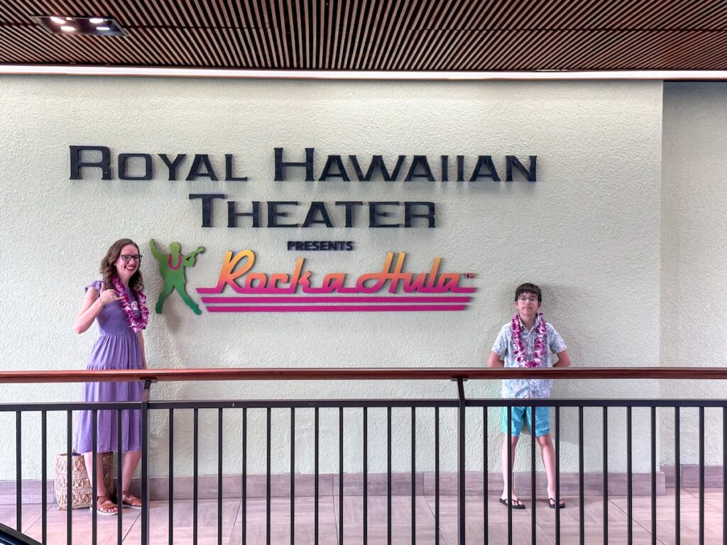 Image of Marcie Cheung of Hawaii Travel with Kids and her son in front of the Rock a Hula sign