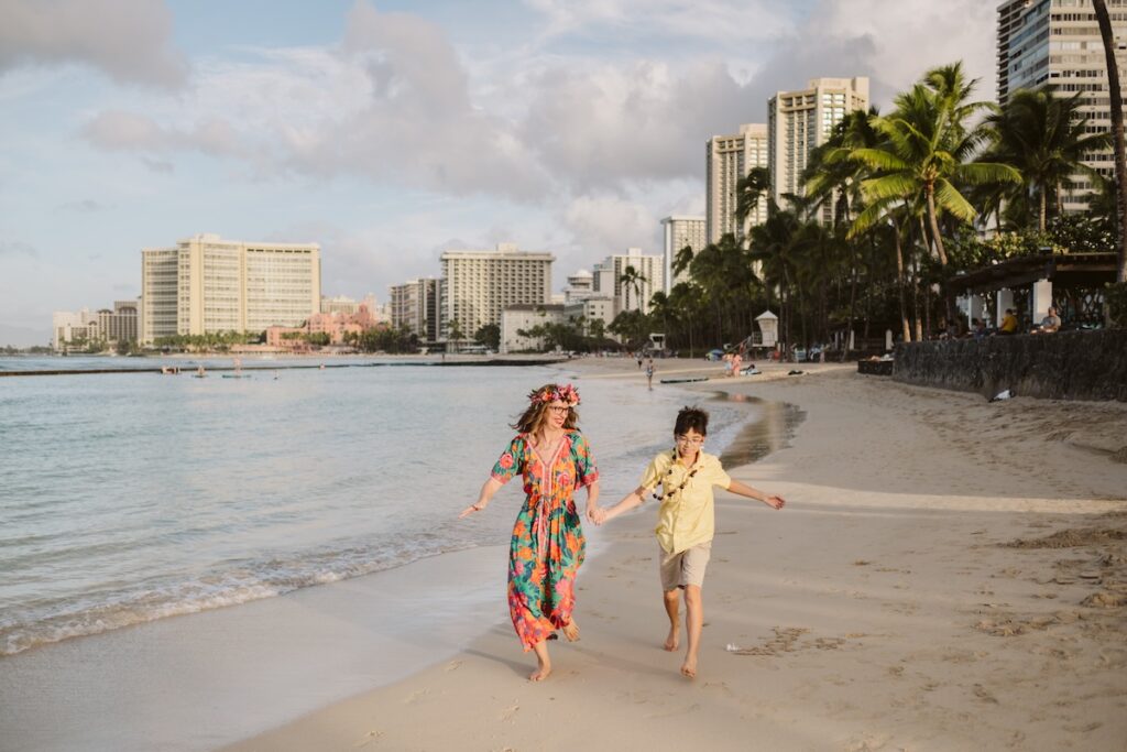 Image of Marcie Cheung of Hawaii Travel with Kids and her son in Waikiki.