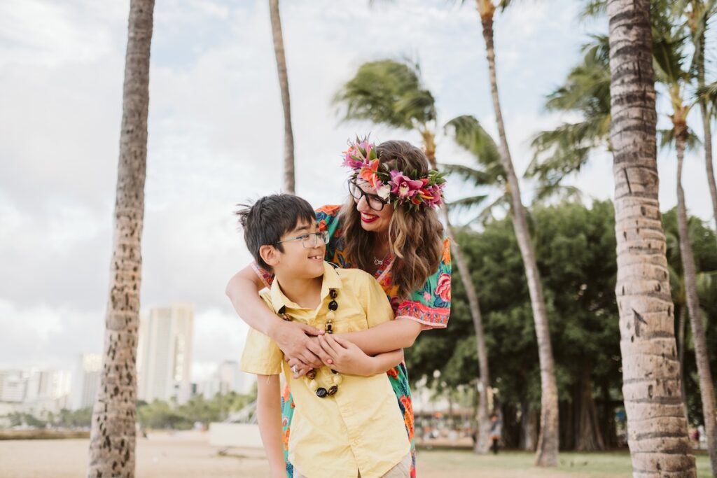 Image of Marcie Cheung of Hawaii Travel with Kids and her son in Waikiki.