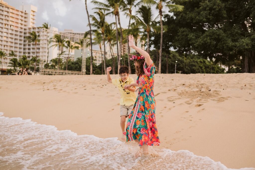 Image of Marcie Cheung of Hawaii Travel with Kids and her son in Waikiki.