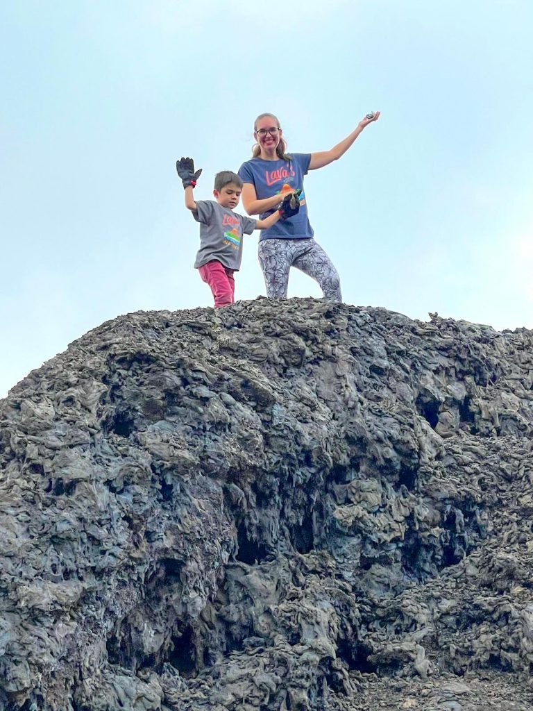 Image of Marcie Cheung and her son climbing on hardened lava at Hawaii Volcanoes National Park