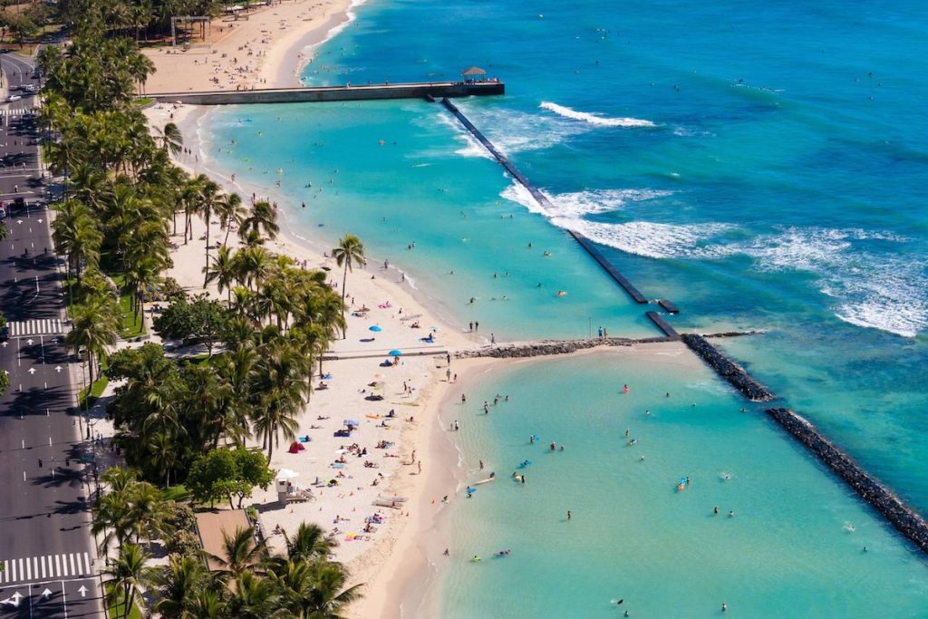 Image of crowded Waikiki beach as seen from a hotel balcony