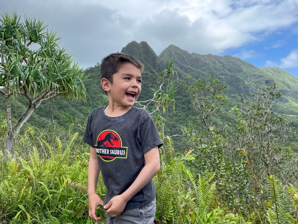See where to find Jurassic Park filming sites in Hawaii with tips from top Hawaii blog Hawaii Travel with Kids. Image of a boy wearing a Jurassic Park shirt in Hawaii