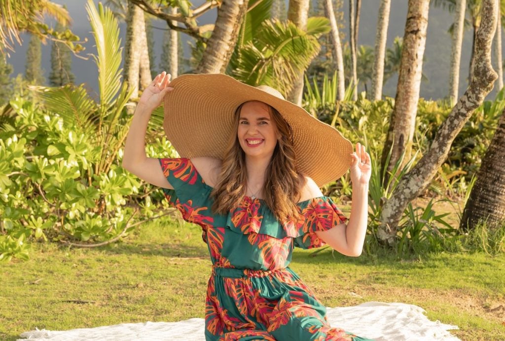 Find out the biggest Kauai mistakes tourists make with travel tips from top Hawaii blog Hawaii Travel with Kids. Image of Marcie Cheung wearing an oversized hat on Kauai.