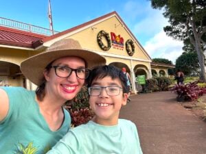Image of Marcie Cheung of Hawaii Travel with kids with her son in front of Dole Plantation.