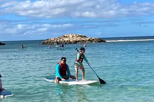 Image of a boy and dad on a paddleboard in Hawaii