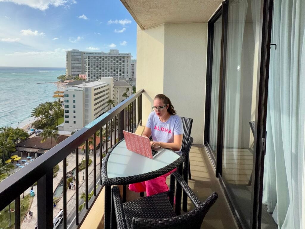 Image of Hawaii travel consultant Marcie Cheung on her laptop at a Waikiki hotel