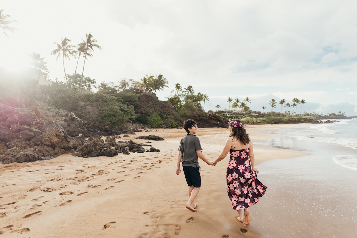 Image of Marcie Cheung and her son on a beach on Maui