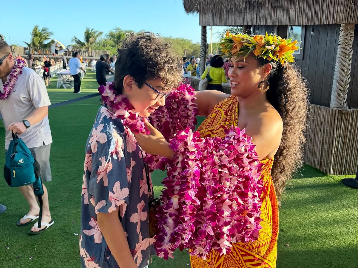 Image of a boy receiving a lei at Mauka Warriors luau on Oahu